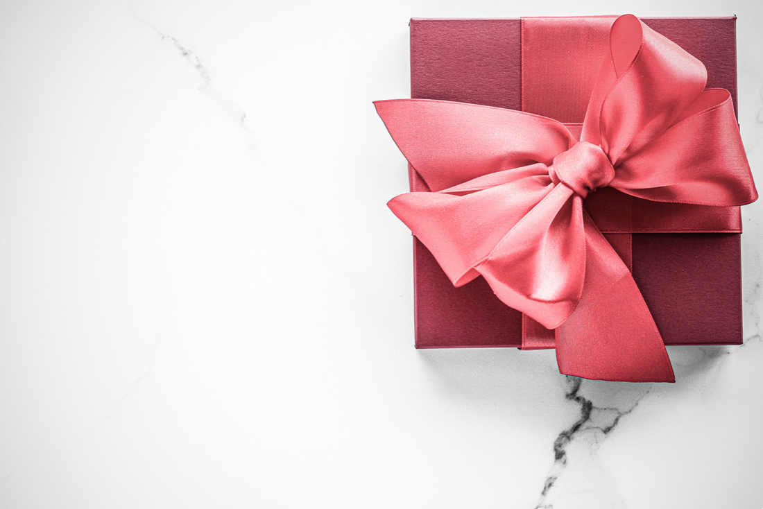 Elegant red gift box, representing thoughtful and heartwarming presents for new mothers curated by Stella Moon Co.