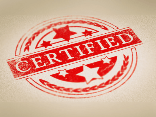 Red certified quality stamp on a textured background, representing OEKO-TEX certification and trust in textile safety.