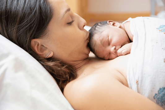 Mother holding her newborn during a quiet moment in the early days of establishing a daily rhythm