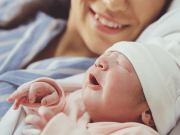 Newborn baby bonding with mother, showcasing their first moments together.