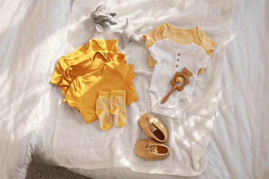 Heirloom baby clothing set with organic cotton pieces and timeless neutral tones