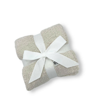 image of luxe baby blanket, with ribbon around it for decorative shipping 