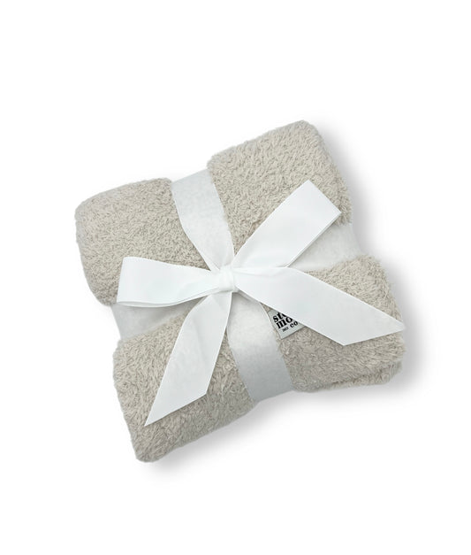 image of luxe baby blanket, with ribbon around it for decorative shipping 