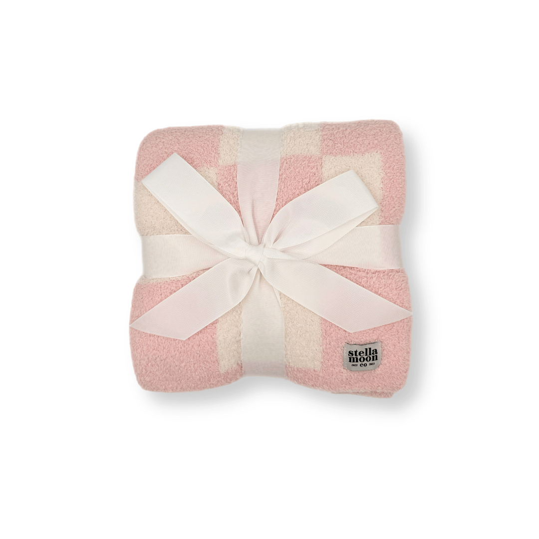 Luxe Checkered Baby Blanket in Baby Pink wrapped with a white ribbon, showcasing its soft fabric and elegant checkered design – perfect for gifting.