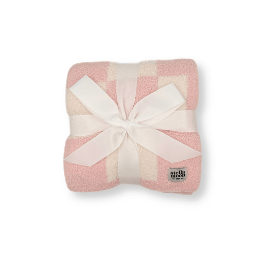 Luxe Checkered Baby Blanket in Baby Pink wrapped with a white ribbon, showcasing its soft fabric and elegant checkered design – perfect for gifting.