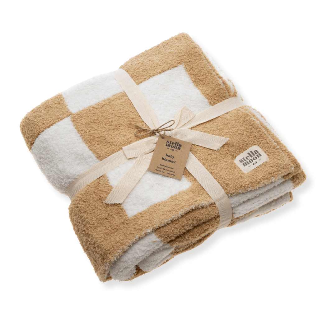 Luxe Checkered Baby Blanket in Sand, folded with a ribbon bow, showcasing its soft checkered design and premium texture.