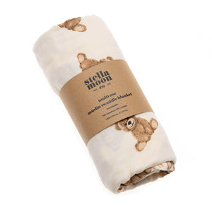 StellaMoon's Multi-use Bamboo Swaddle in Teddy, laid out flat showcasing its warm teddy bear hue. The finely woven texture is highlighted, emphasizing the luxurious blend of bamboo and cotton. Perfect for swaddling, nursing, or shielding a baby in comfort.