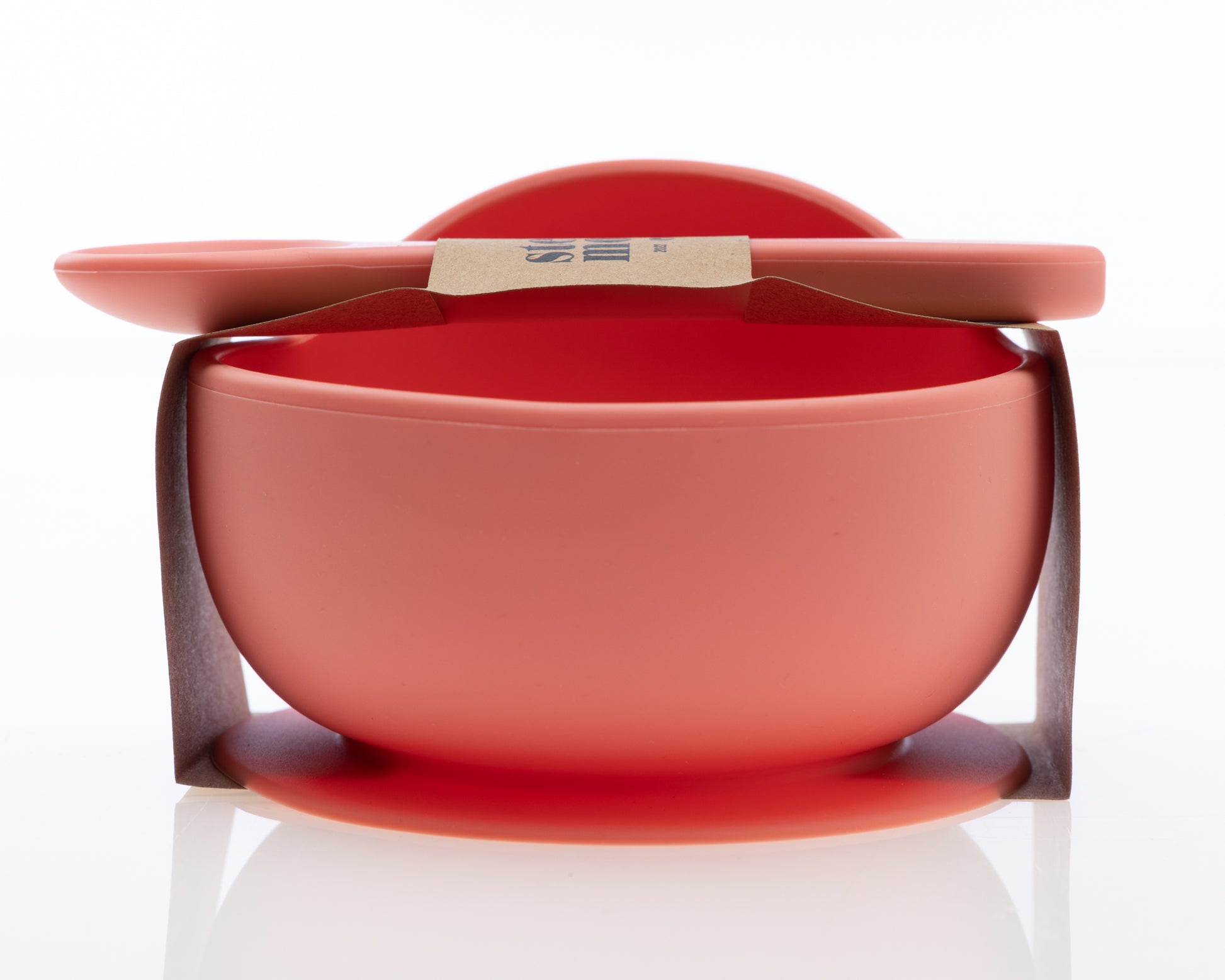 Side view of StellaMoon Silicone Suction Bowl and Spoon Set in Sherbert, demonstrating the bowl's ample depth and the comfortable design of the spoon.